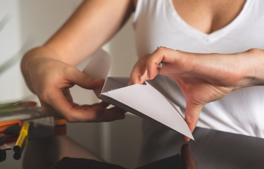 woman-holding-an-envelope-3951841 A close-up image showing hands sealing a white envelope on a polished surface. Perfect for business or communication concepts.